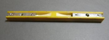 Yellow plastic mounting rail with metal plates